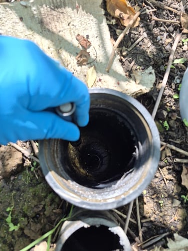 a bluefrog Plumber investigating an outdoor downspout drain in Northwest Portland.