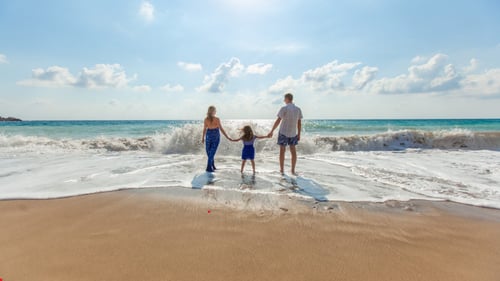 Family holding hands at a beach
