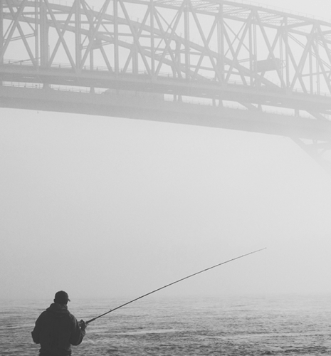 A man fishing near the Blue Water Bridge in Sarnia, Ontario.