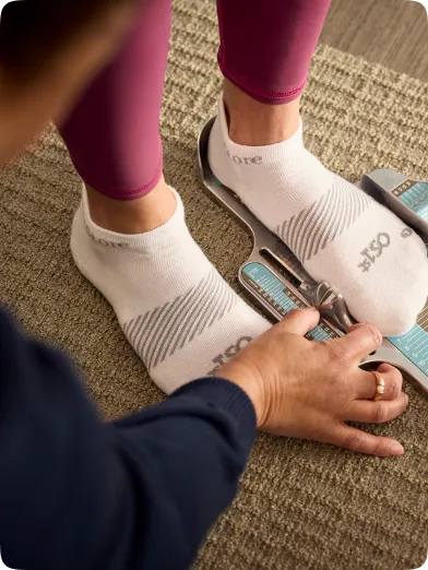 customer placing their foot in brannock device