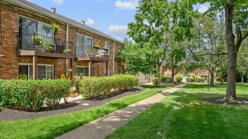 A sidewalk in front of a brick apartment building at Olde Towne in Kenwood, Cincinnati, 45243