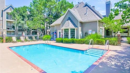 Pool view with clubhouse in the back at Riverside Park Apartments, Tulsa, Oklahoma