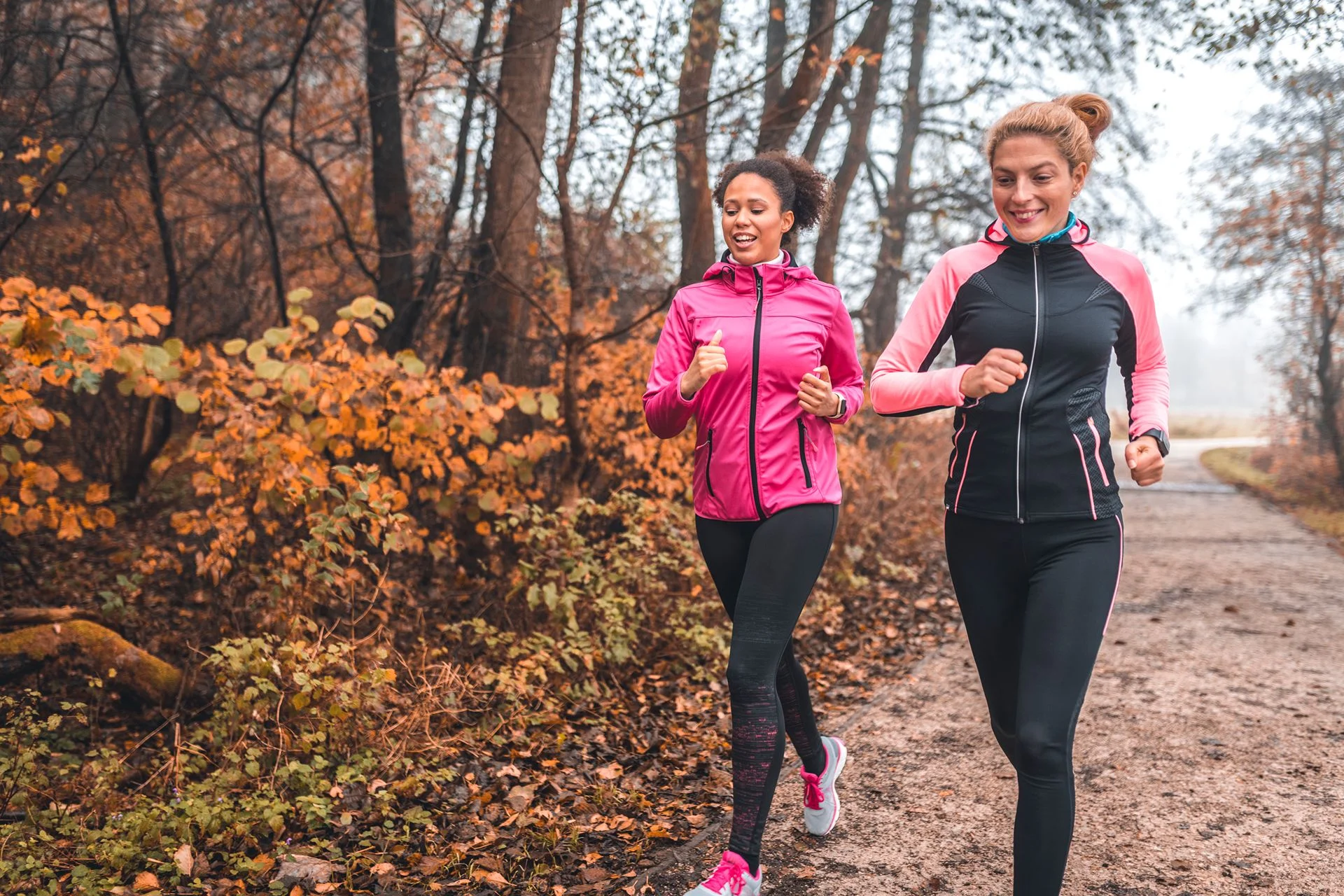 two people happily on a a trail run