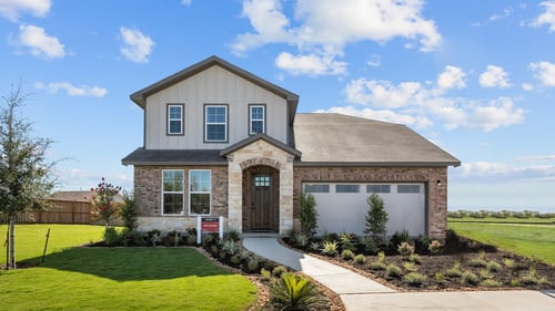 exterior with brick, stone & a covered porch