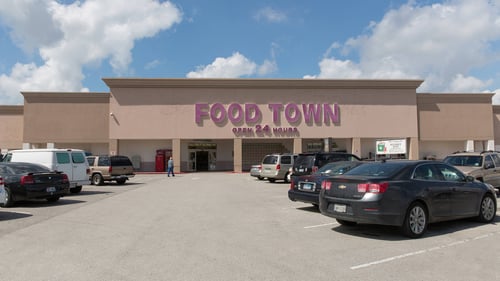 Cars parked at an angle in front of Food Town at Parktown Shopping Center