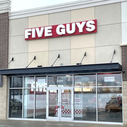 Exterior photograph of the entrance to the Five Guys restaurant at 2006 East Beltline Ave. NE in Grand Rapids Michigan.