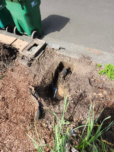 A leak at the water meter at this Northeast Portland Property required an urgent fix