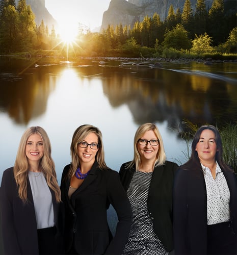 Four members of the Parisien Millar Wealth Management team in professional attire with a mountain river landscape backdrop.