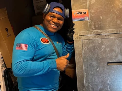 You and Us Heating & Air Conditioning employee giving a thumbs up