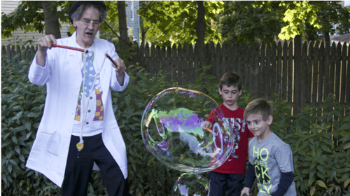 magician doing tricks in front of children