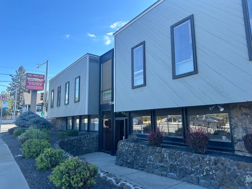 The front of Doctor James Ohman's Office. Beautiful blue skies with shrubbery infront.