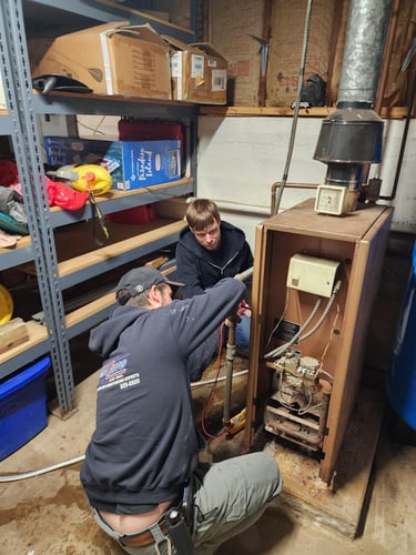 Technicians repairing a heating unit