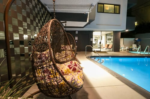 Pool side relaxing chair at Westwood Riviera Apartments, California, 90024