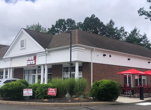 Exterior photograph of the Five Guys restaurant at 266-274 South Main Street in Newtown, Connecticut.
