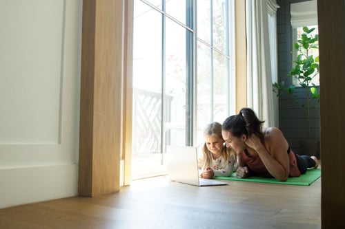 Mother and daughter doing yoga while using Wi-Fi