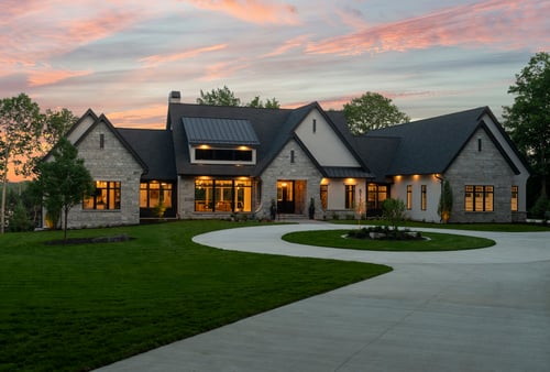 Evening view of a high-end custom residence, highlighting lighting design and exterior materials