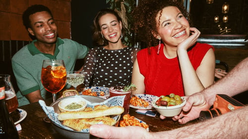 Photo of group of friends enjoying their meal.