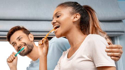 two people brushing their teeth