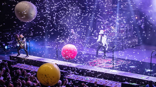 Alice Cooper and band on stage at Swansea Arena, during climax of show with confetti and inflatable balloons