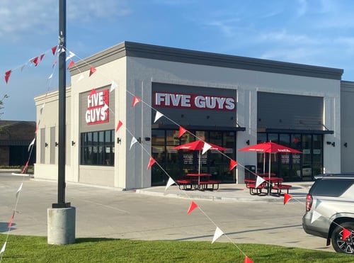 Exterior photograph of the Five Guys restaurant at 625 West Highway 30 in Gonzales, Louisiana.