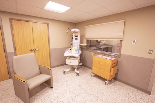 Another view of the nursery showing a bassinet, infant warmer and other equipment