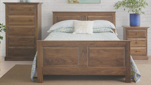 bed with a wooden bed frame, wooden nightstand, and dresser