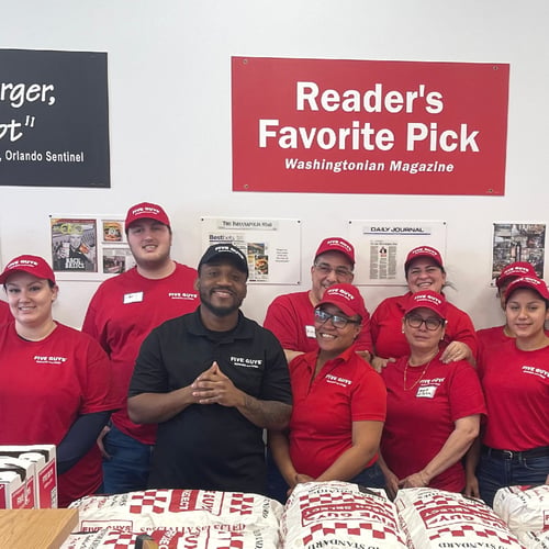 Employees pose for a photograph inside the restaurant ahead of the reopening of the Five Guys at 197 Boston Post Road West in Marlborough Massachusetts.