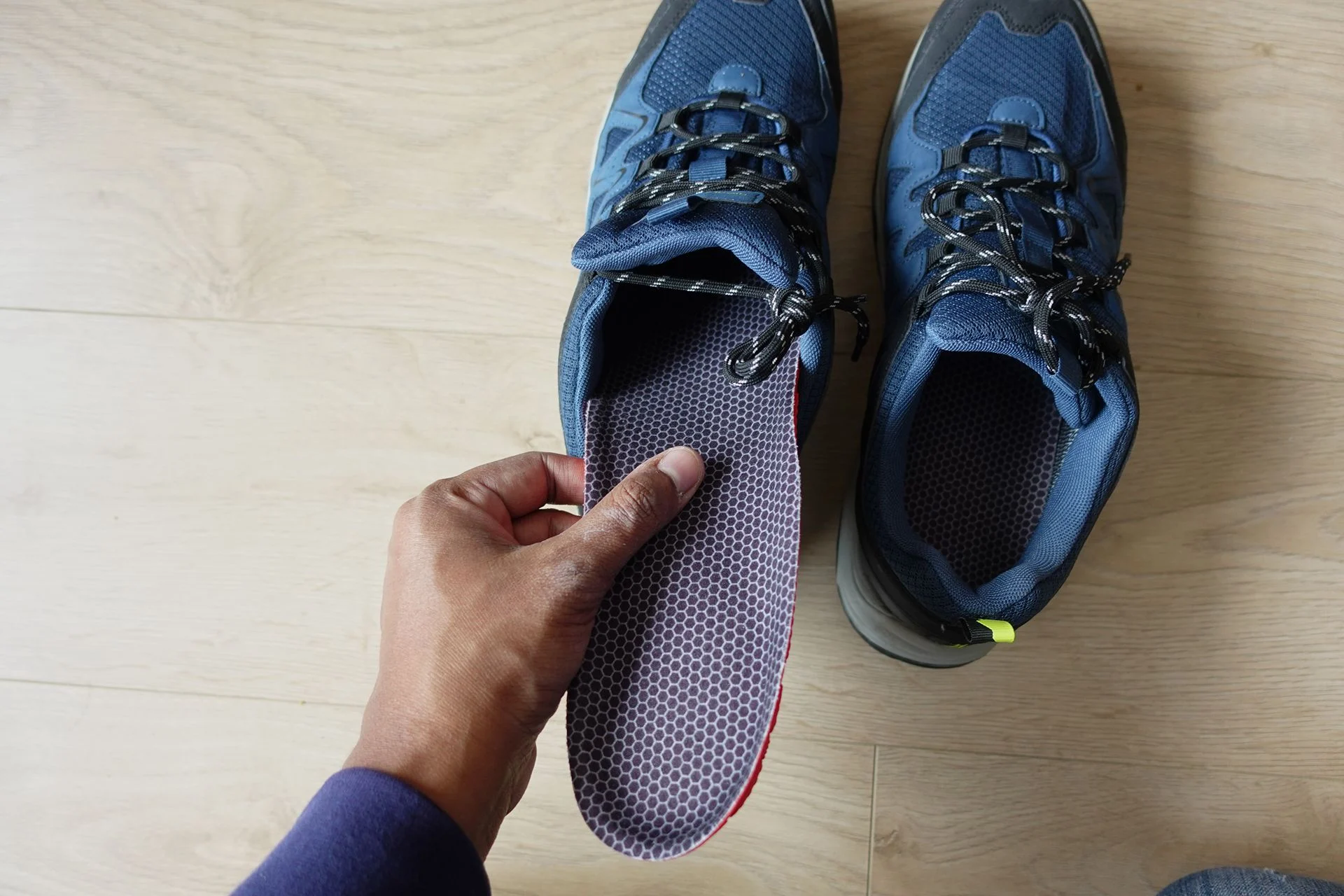 Person inserting arch support into their shoes