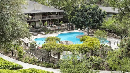 an aerial view of a garden with a clubhouse and swimming pool at The Aspens Fairhaven in Santa Ana, CA, 92705