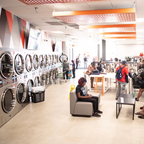 Customers doing laundry inside a spacious Speed Queen Laundry