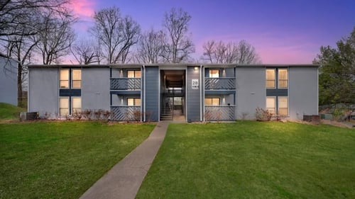 A modern building with a walkway leading to the entrance at The Beacon, Huntsville, AL, 35816