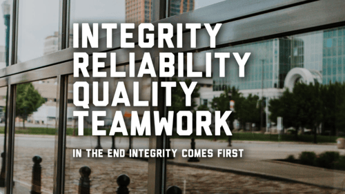 text reading INTEGRITY - RELIABILTY - QUALITY - TEAMWORK with commerical building behind