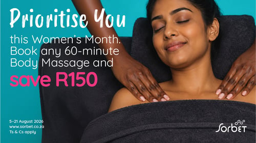 A woman with her eyes closed relaxes during a shoulder massage while a therapist's hands massage her neck and shoulders.