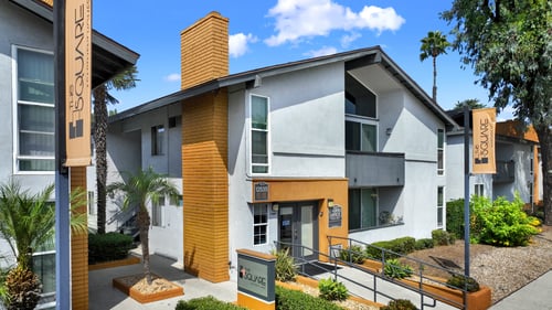 A building with a sign at The Square in Downey, CA, 90242