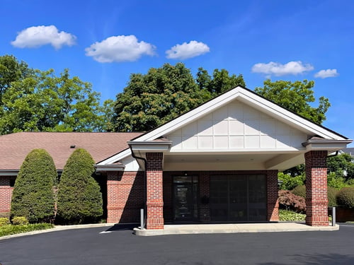 Front exterior view of the Novant Health Pilot Mountain Medical Care with two brick columns and a covered entrance.