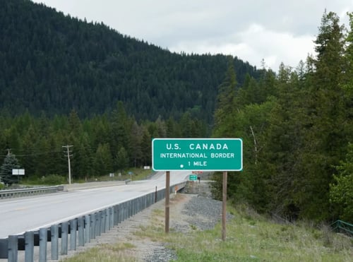 U.S and Canada border sign along a highway