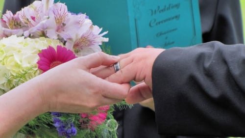 Couple holding hands during a wedding cremony