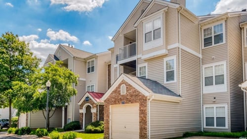 A large apartment building with a garage door in front at Park at Winterset Apartments, Owings Mills, Maryland