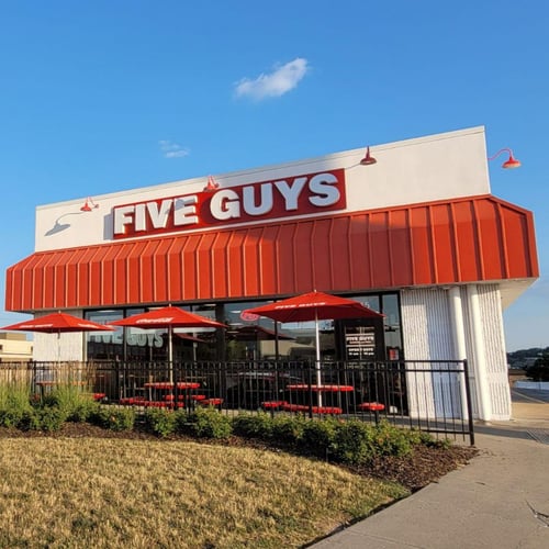 Exterior photograph of the Five Guys restaurant at 7345 Dodge Street in Omaha Nebraska.