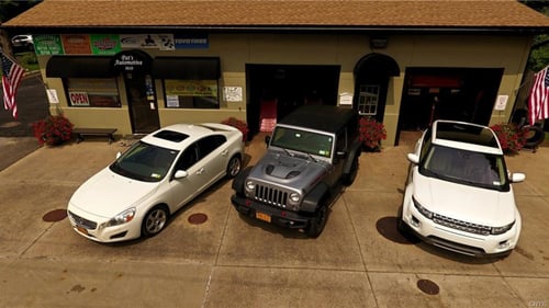 three cars outside garage