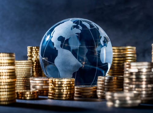 Stack of coins around a marble globe