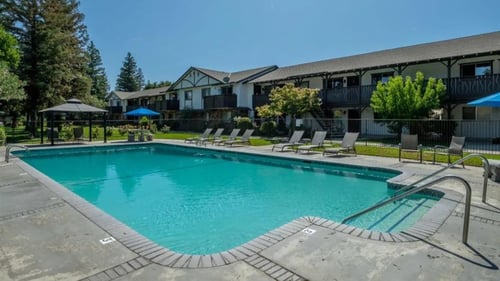 pool deck and sun lounges at Scottsmen Too Apartment homes in Clovis, CA
