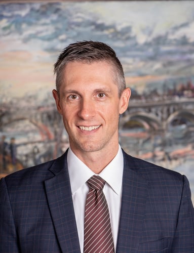 Daniel Hulak's headshot in front of some artwork
