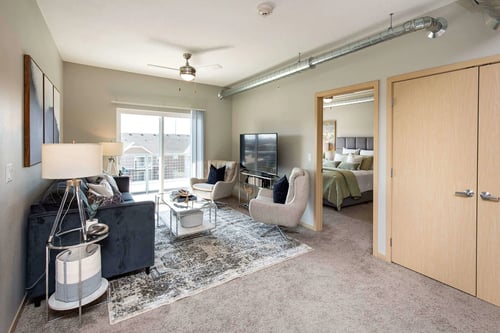 Living room with spacious closet, sofa, chairs, Lake Shore Apartments, Ankeny, IA