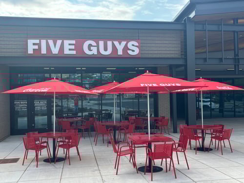 Exterior photograph of the Five Guys restaurant at 1606 Commonwealth Avenue in Charlotte, North Carolina.
