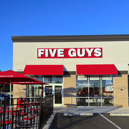 Exterior photograph of the Five Guys restaurant at 23992 US Highway 80 East in Statesboro Georgia.