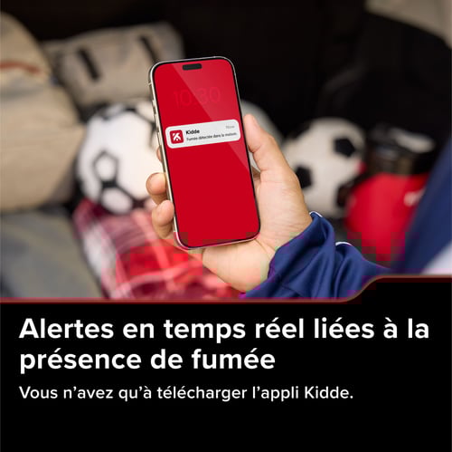 A person holds their phone with a notification from Ring