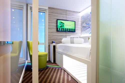 hub by Premier Inn bedroom with TV and chair