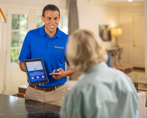 Teach assisting homeowner with the water damage process