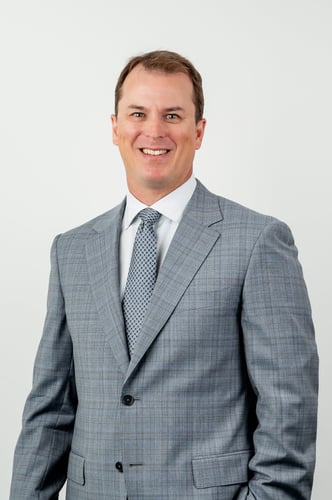 Headshot of Kevin Thomas in grey suit